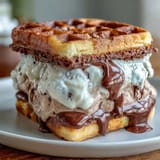 Vanilla Bean Frappuccino Ice Cream Sandwiches on a white plate, creamy vanilla bean ice cream between rich espresso cookies, perfect frozen treat.