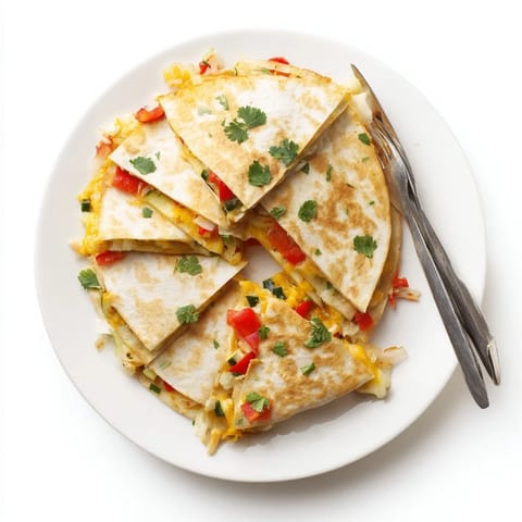 A close-up of cheesy vegetable quesadilla wedges served on a plate with salsa.