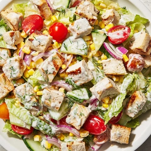 This vibrant Ranch Chicken Chopped Salad features corn, sharp cheddar, and creamy Greek yogurt ranch dressing drizzled over fresh greens.